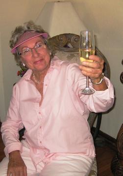 Mardie Schroeder, holding a glass of white wine